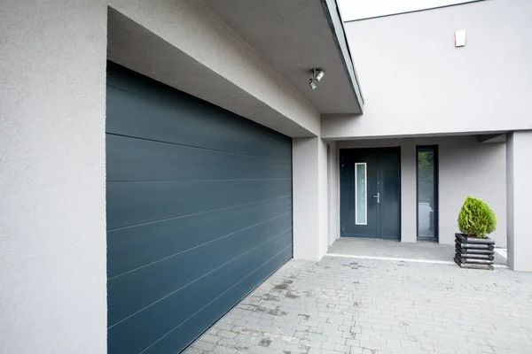 Garage door service technician working on residential garage door